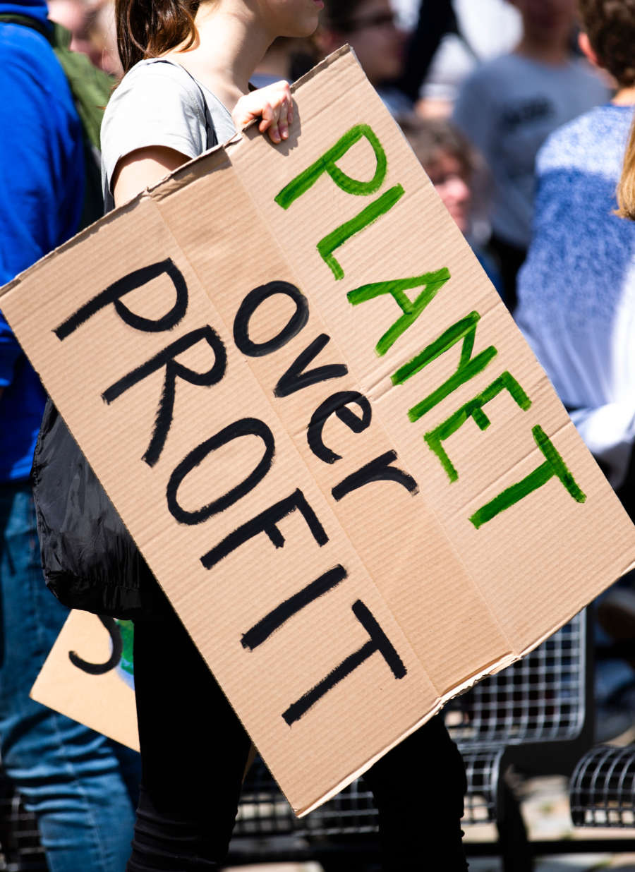 'Planet Over Profit' sign | photo by Markus Spiske via Unsplash